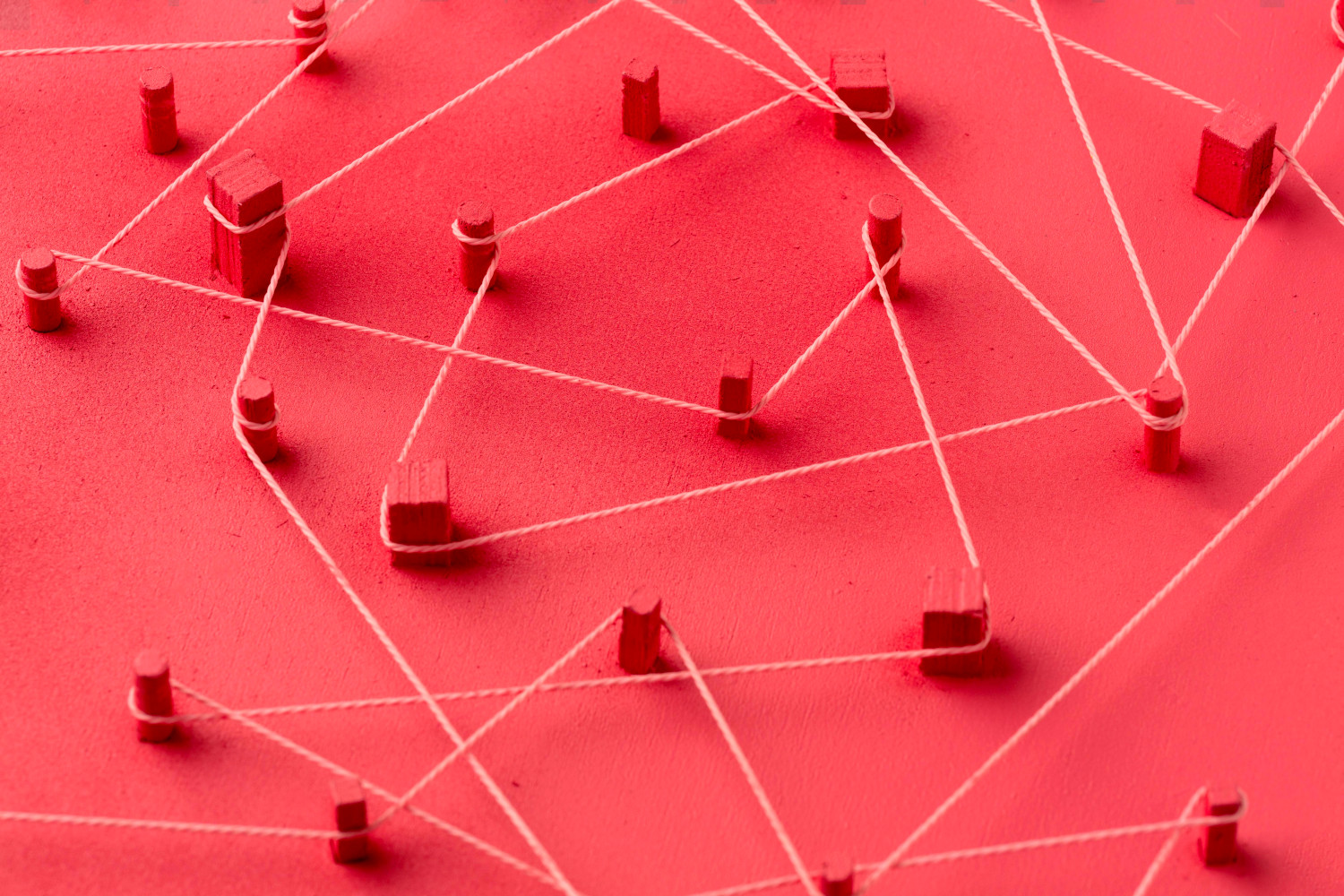 A red board with many pages connected together with wrapped twine