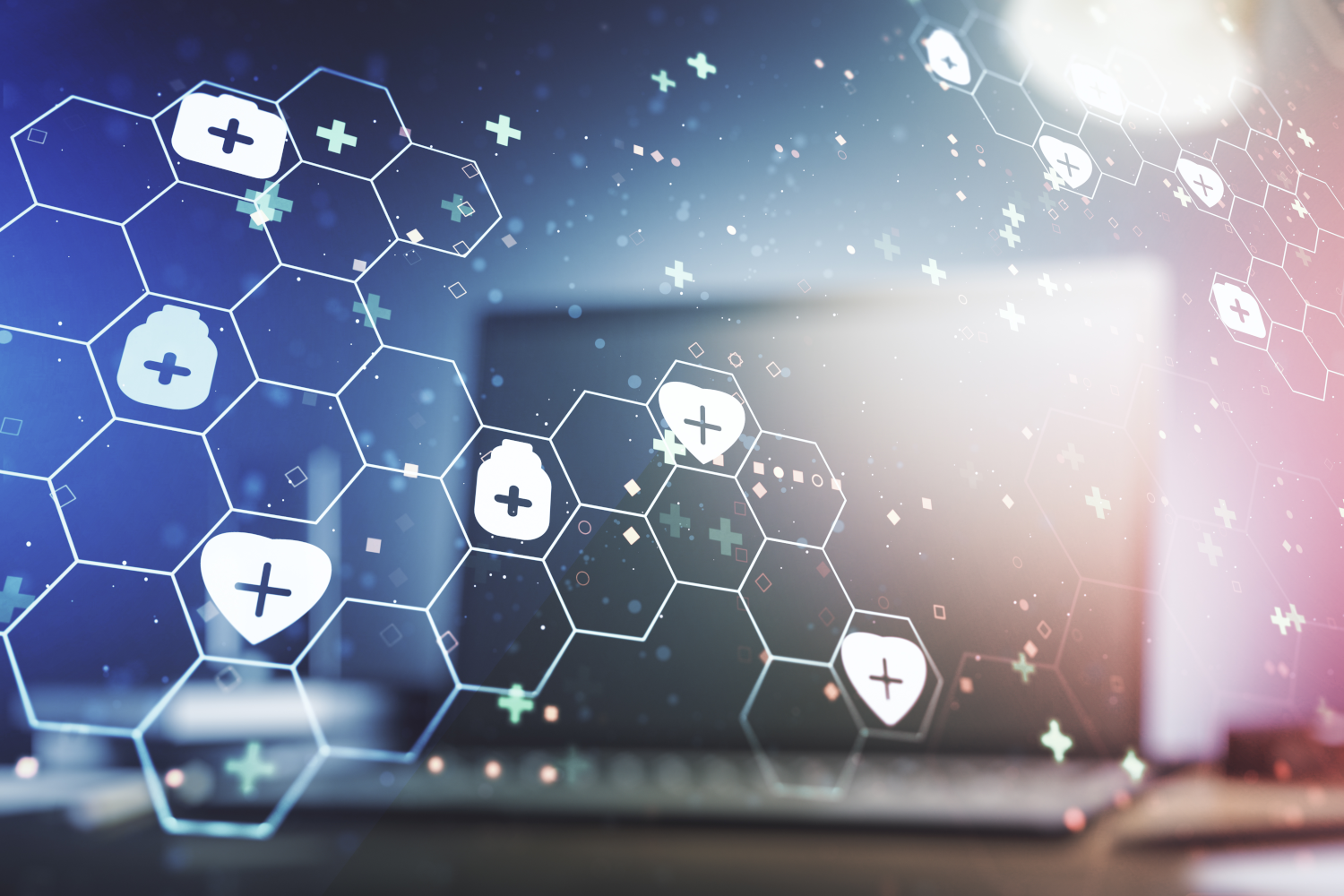 A honeycomb with various medical shapes overlaying a laptop