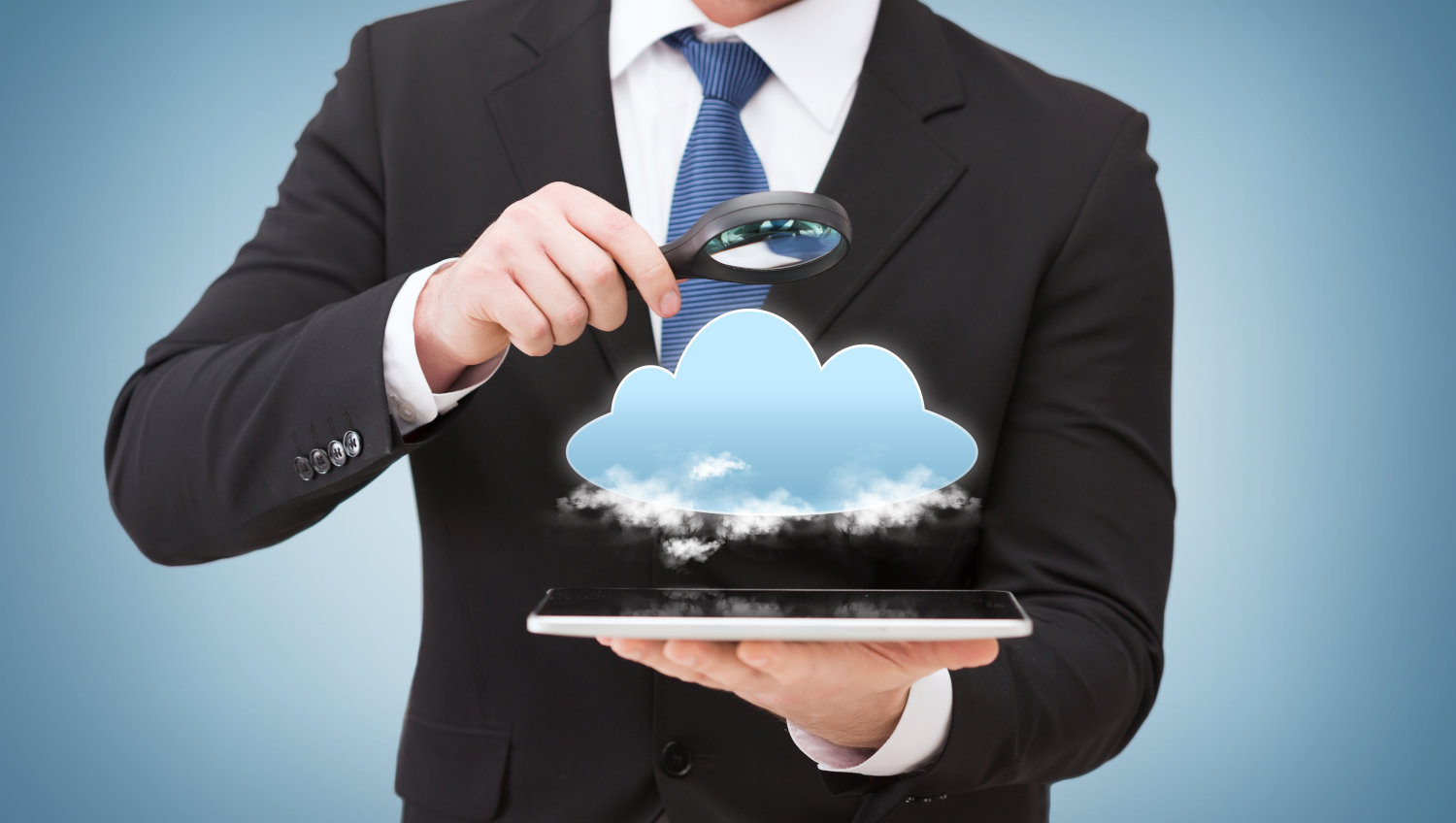 A man holding a tablet with a cloud floating over it that the man is inspecting with a magnifying glass