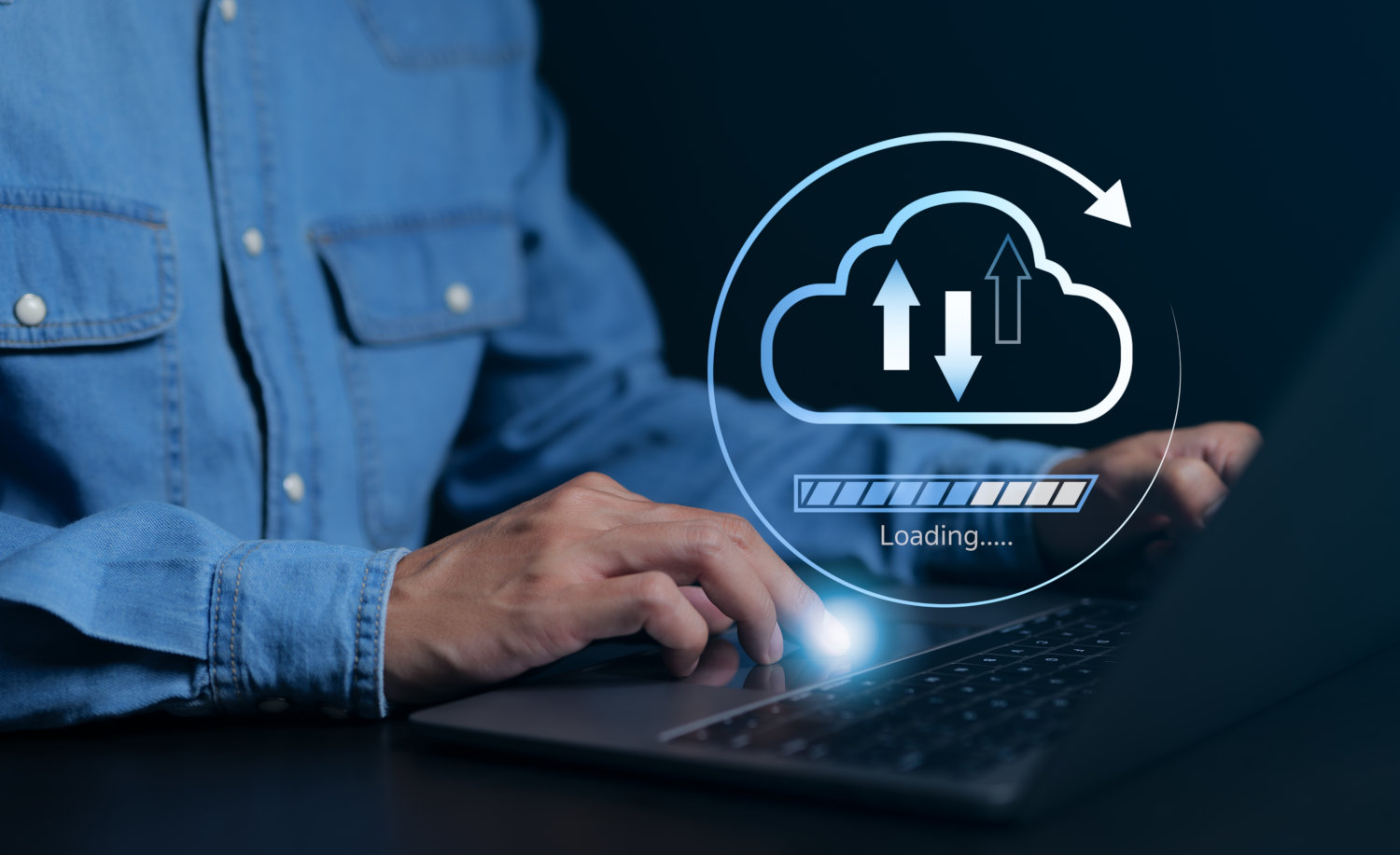 A man using a laptop with a cloud containing up and down arrows with a loading indicator